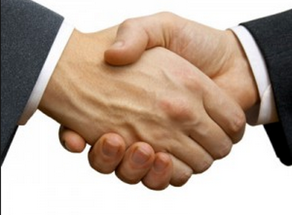 two financial advisors shaking hands because of a win